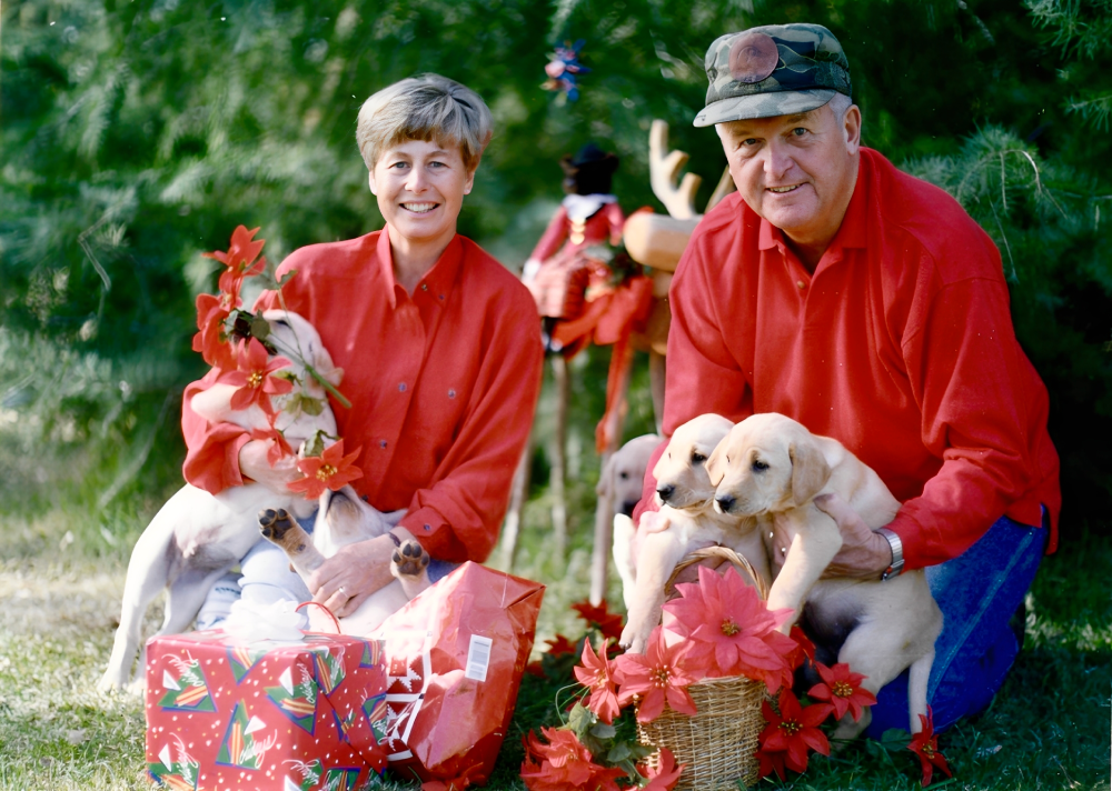 Couple with puppies and Christmas gifts