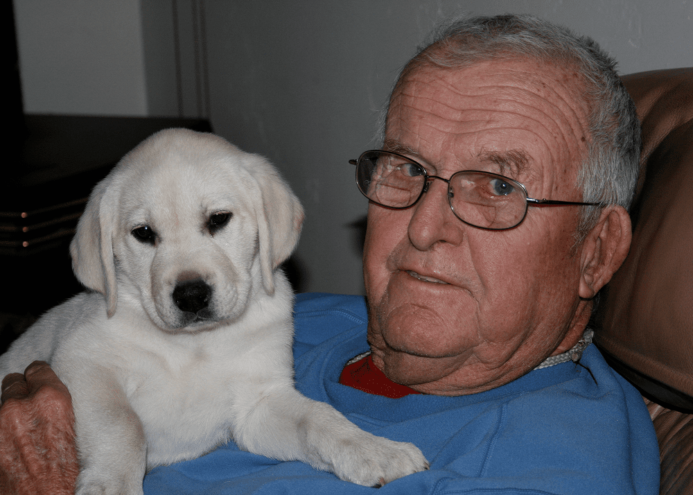 Man and puppy sitting together